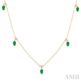 5x3 MM Oval Shape Emerald and 1/8 Ctw Round Cut Diamonds Precious Station Necklace in 10K Yellow Gold